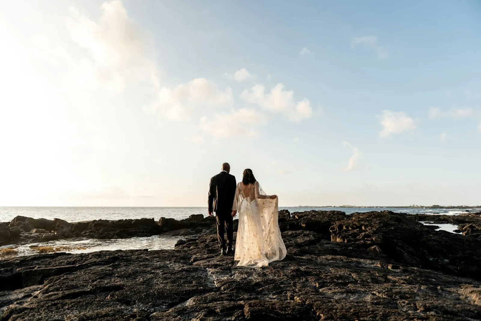 A couple standing together on a wild coastline